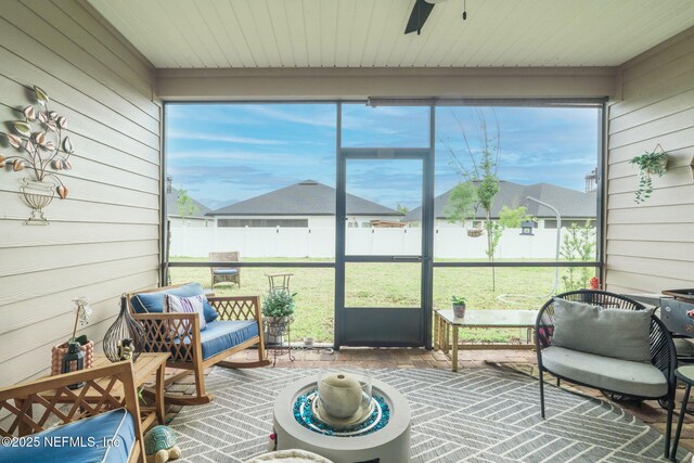 sunroom / solarium featuring ceiling fan