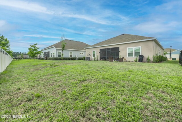 rear view of property featuring a sunroom and central air condition unit