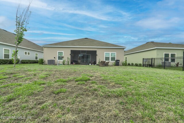 rear view of property featuring central air condition unit and a sunroom
