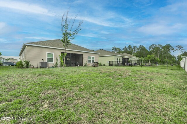 back of property featuring central air condition unit and a sunroom