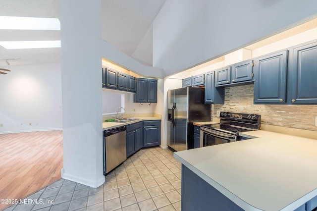 4837 Wethersfield Pl W, Jacksonville, FL 32257 - kitchen featuring appliances with stainless steel finishes, a sink, blue cabinetry, light countertops, and light tile patterned floors