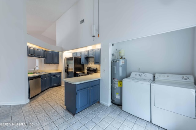 4837 Wethersfield Pl W, Jacksonville, FL 32257 - washroom with electric water heater, washer and dryer, light tile patterned floors, and baseboards