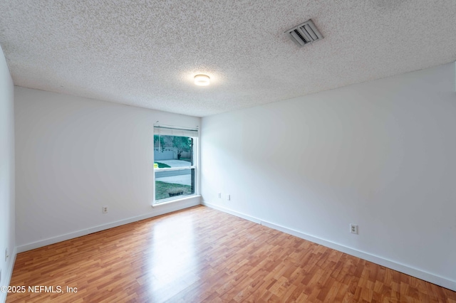 4837 Wethersfield Pl W, Jacksonville, FL 32257 - unfurnished room featuring wood finished floors, baseboards, and a textured ceiling