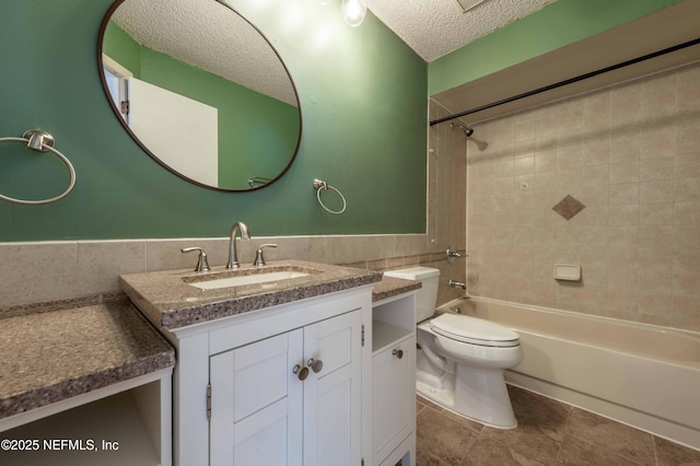 4837 Wethersfield Pl W, Jacksonville, FL 32257 - full bathroom with a textured ceiling, vanity, toilet, shower / bathtub combination, and tile walls