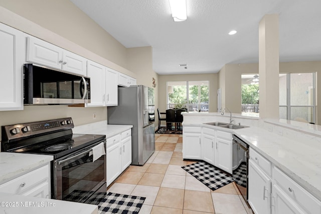 11658 Jerry Adam Ct, Jacksonville, FL 32218 - kitchen featuring stainless steel appliances, a sink, white cabinets, and light stone counters