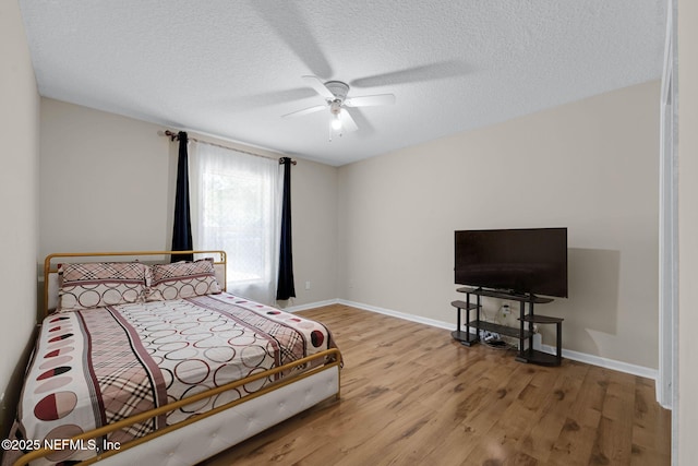 11658 Jerry Adam Ct, Jacksonville, FL 32218 - bedroom featuring wood finished floors, baseboards, a textured ceiling, and ceiling fan