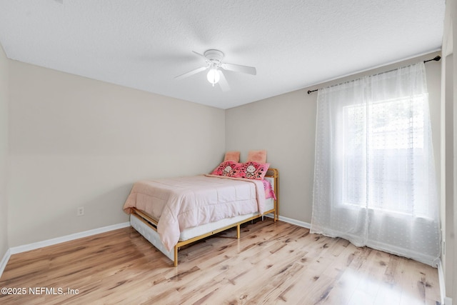 11658 Jerry Adam Ct, Jacksonville, FL 32218 - bedroom featuring wood finished floors, baseboards, a textured ceiling, and ceiling fan