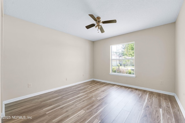 11658 Jerry Adam Ct, Jacksonville, FL 32218 - spare room featuring wood finished floors, a ceiling fan, baseboards, and a textured ceiling