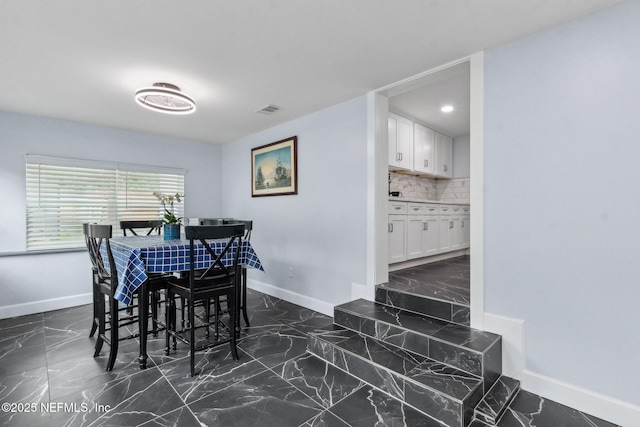 1874 Clinch Dr, Fernandina Beach, FL 32034 - dining room with baseboards, dark marble finish flooring, and recessed lighting