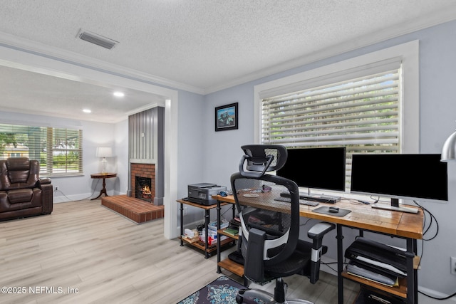 1874 Clinch Dr, Fernandina Beach, FL 32034 - office featuring crown molding, wood finished floors, a brick fireplace, baseboards, and a textured ceiling
