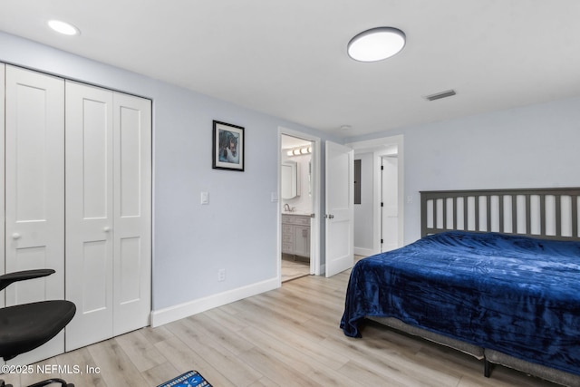 1874 Clinch Dr, Fernandina Beach, FL 32034 - bedroom featuring wood finished floors, baseboards, connected bathroom, recessed lighting, and a closet