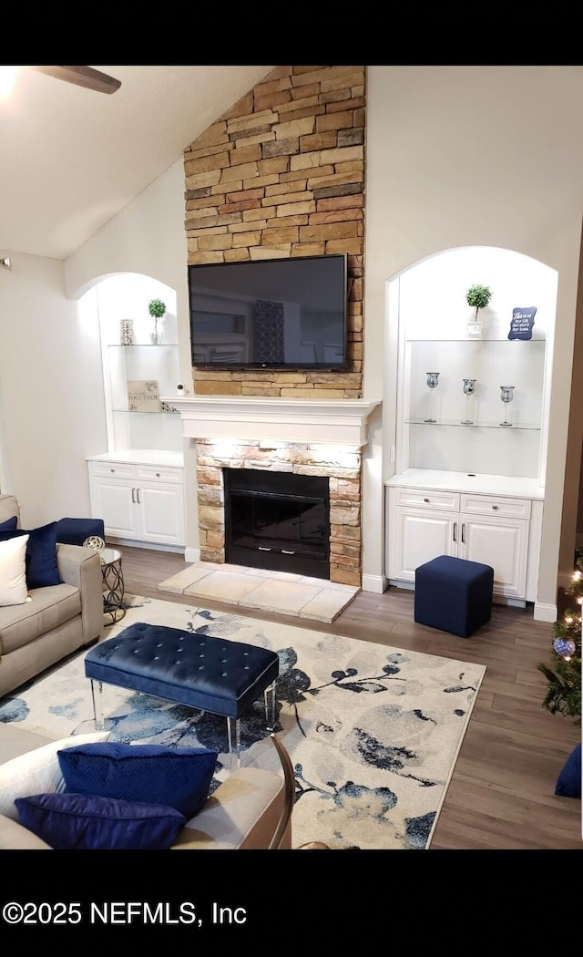 1949 Woodworth Dr, Orange Park, FL 32065 - living room featuring wood finished floors, lofted ceiling, and a stone fireplace