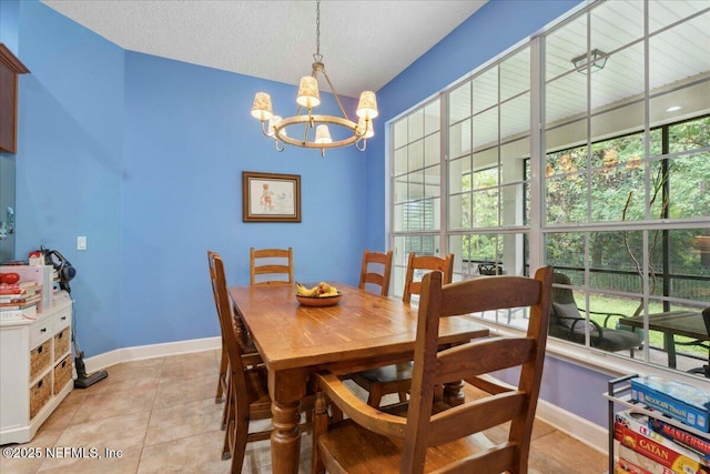 dining area with a chandelier, baseboards, and light tile patterned floors