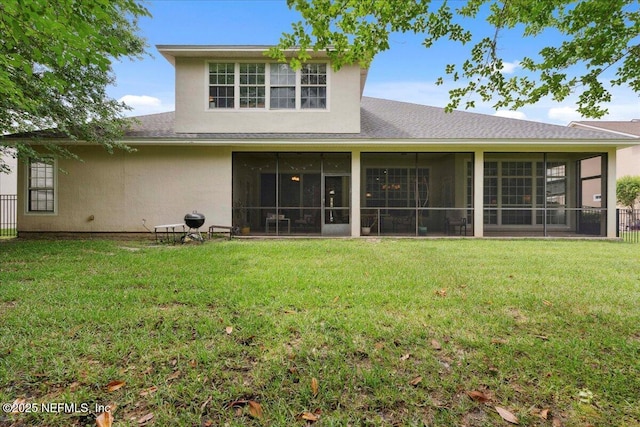 back of house with a sunroom, roof with shingles, and stucco siding