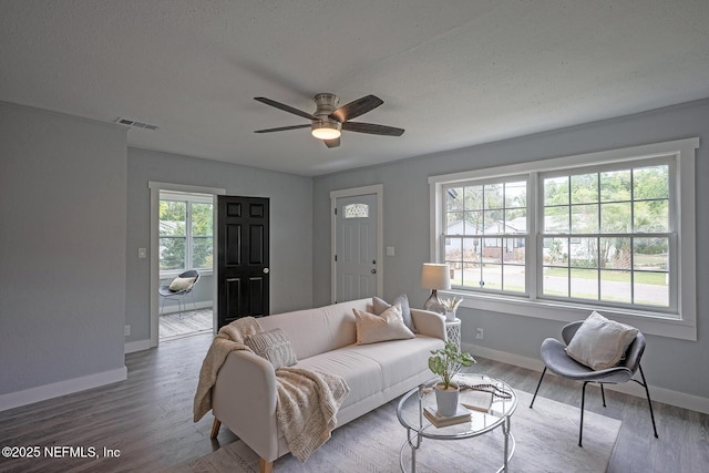 304 Lawton Ave, Jacksonville, FL 32208 - living area featuring baseboards, wood finished floors, and ceiling fan