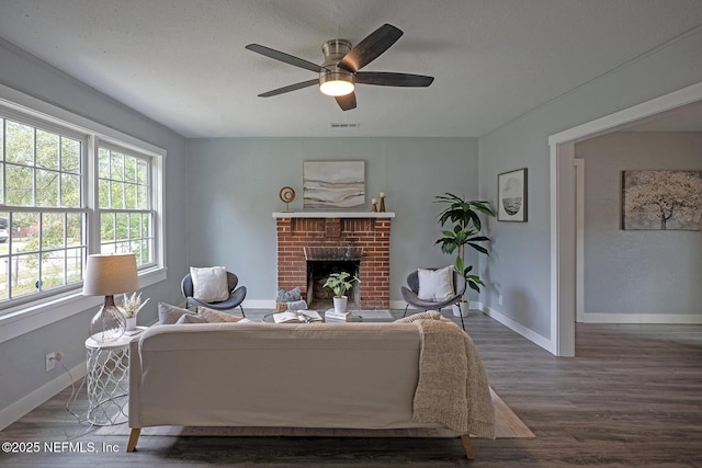 304 Lawton Ave, Jacksonville, FL 32208 - living area featuring wood finished floors, a ceiling fan, a fireplace, baseboards, and a textured ceiling