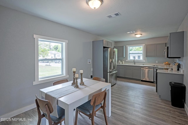 304 Lawton Ave, Jacksonville, FL 32208 - dining area with light wood-type flooring and baseboards
