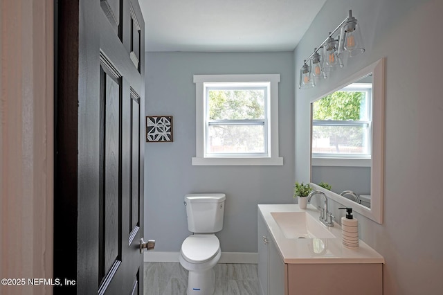 304 Lawton Ave, Jacksonville, FL 32208 - bathroom with toilet, healthy amount of natural light, baseboards, and vanity