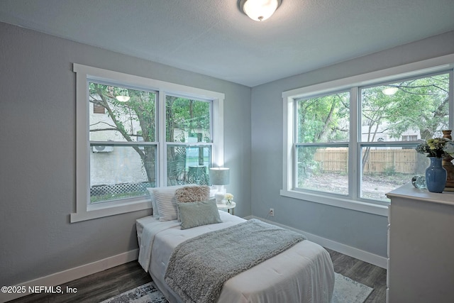 304 Lawton Ave, Jacksonville, FL 32208 - bedroom with multiple windows, baseboards, and dark wood finished floors