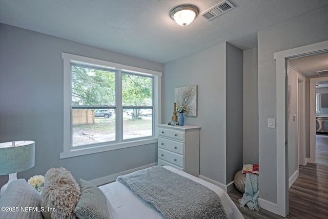 304 Lawton Ave, Jacksonville, FL 32208 - bedroom featuring baseboards, dark wood finished floors, and a textured ceiling