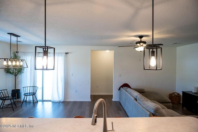 1863 Maxine Branch Way, Jacksonville, FL 32218 - living room with wood finished floors, a textured ceiling, ceiling fan, and baseboards