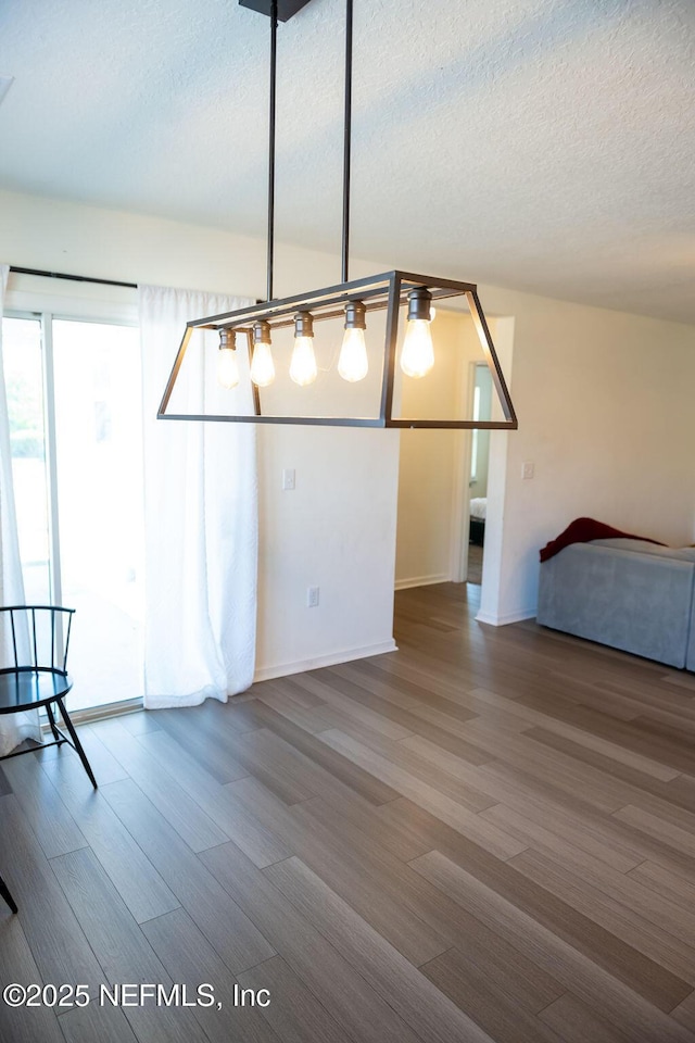1863 Maxine Branch Way, Jacksonville, FL 32218 - unfurnished dining area with wood finished floors, a textured ceiling, and baseboards