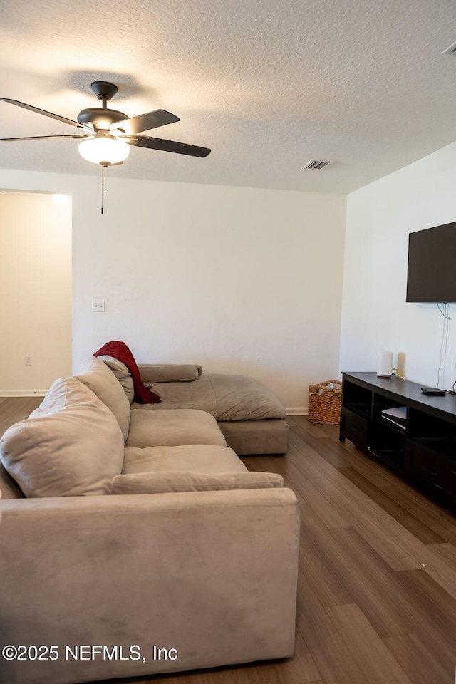 1863 Maxine Branch Way, Jacksonville, FL 32218 - living area featuring wood finished floors, baseboards, a ceiling fan, and a textured ceiling
