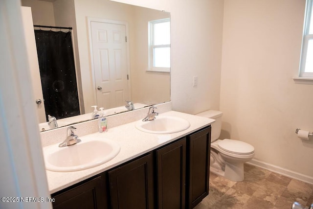 1863 Maxine Branch Way, Jacksonville, FL 32218 - bathroom with toilet, double vanity, and baseboards