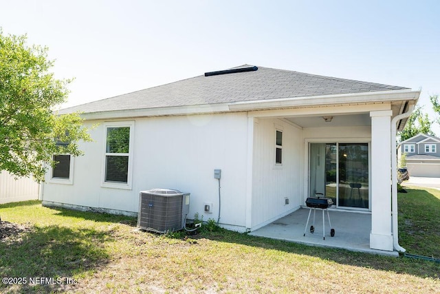 1863 Maxine Branch Way, Jacksonville, FL 32218 - back of house with central air condition unit, a patio, a yard, and a shingled roof