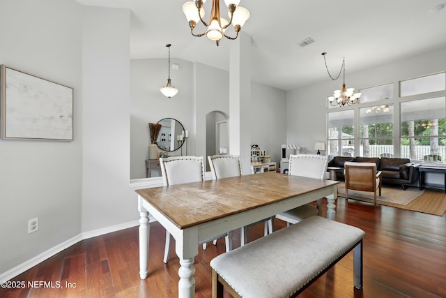 100 Bracken Ct, Saint Johns, FL 32259 - dining space featuring a chandelier, high vaulted ceiling, arched walkways, wood finished floors, and baseboards