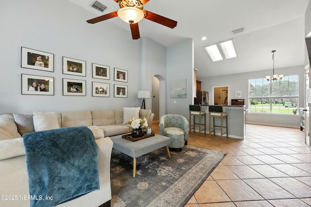 100 Bracken Ct, Saint Johns, FL 32259 - living area with arched walkways, a chandelier, light tile patterned floors, a ceiling fan, and baseboards