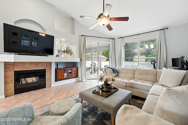 100 Bracken Ct, Saint Johns, FL 32259 - living room featuring vaulted ceiling, a tile fireplace, tile patterned flooring, a ceiling fan, and baseboards