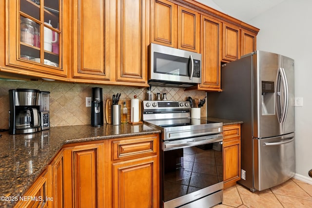100 Bracken Ct, Saint Johns, FL 32259 - kitchen featuring appliances with stainless steel finishes, brown cabinetry, and tasteful backsplash