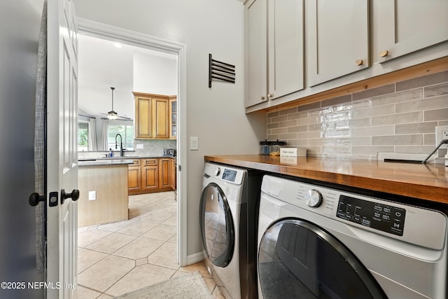 100 Bracken Ct, Saint Johns, FL 32259 - clothes washing area featuring washer and clothes dryer, cabinet space, and light tile patterned floors