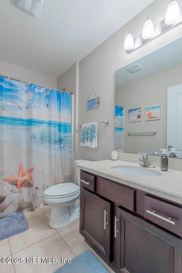 full bath with tile patterned floors, vanity, toilet, a textured ceiling, and curtained shower