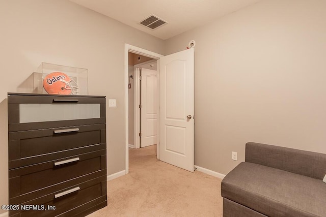 living area with light colored carpet and baseboards