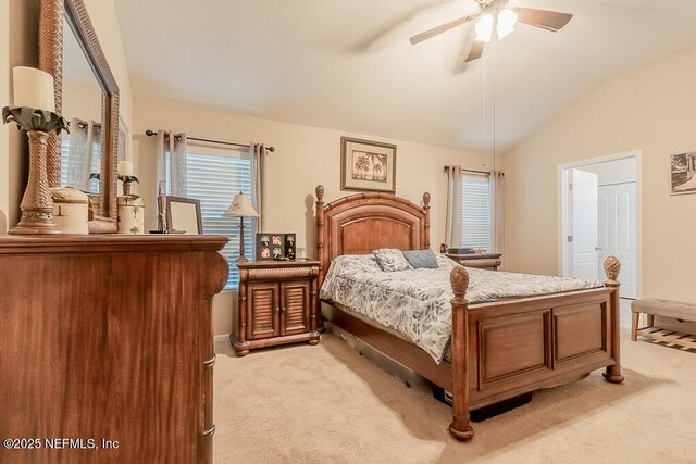 bedroom with light colored carpet, vaulted ceiling, and ceiling fan