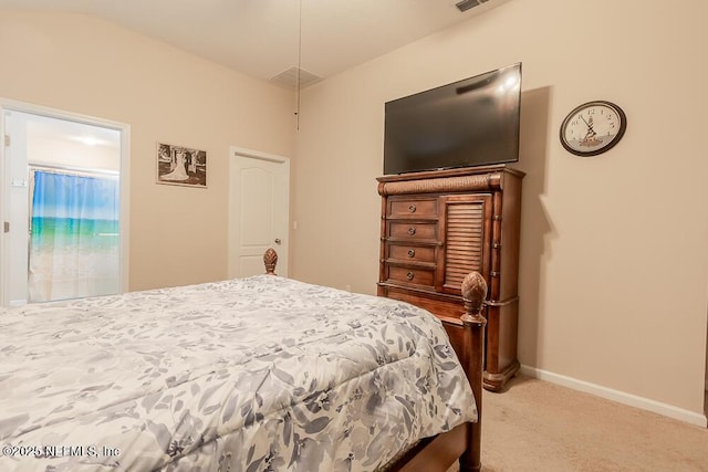 bedroom featuring light carpet and baseboards