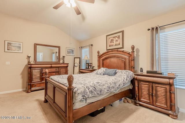 bedroom with light colored carpet, lofted ceiling, baseboards, and a ceiling fan