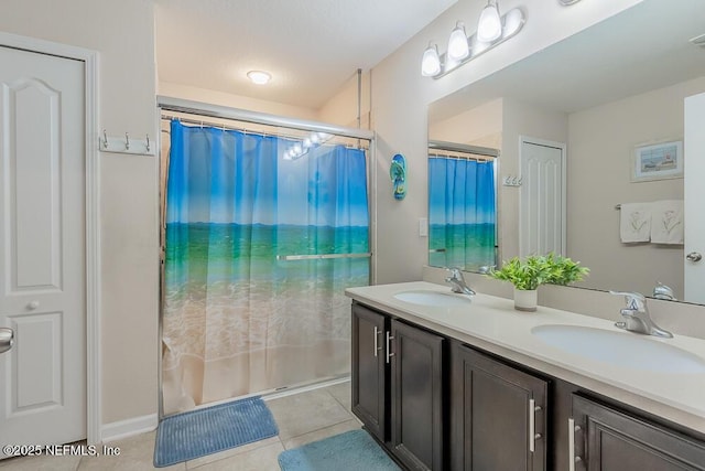 bathroom featuring tile patterned floors, double vanity, and curtained shower