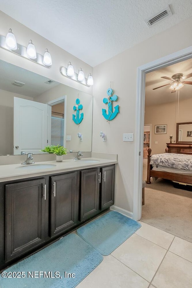 bathroom featuring double vanity, tile patterned floors, connected bathroom, a ceiling fan, and baseboards