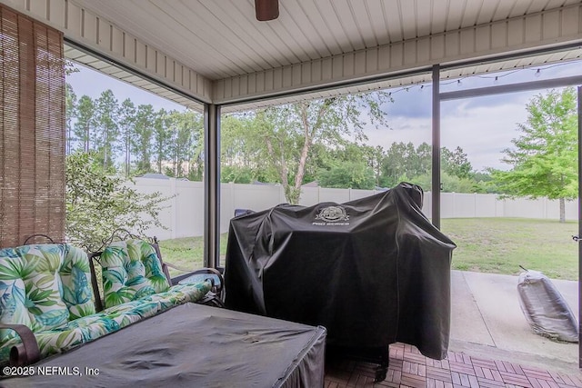sunroom with ceiling fan and plenty of natural light