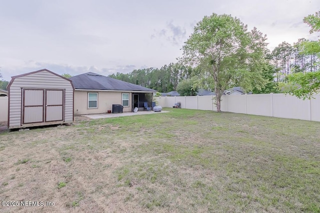 view of yard featuring a patio, a storage shed, and an outdoor structure