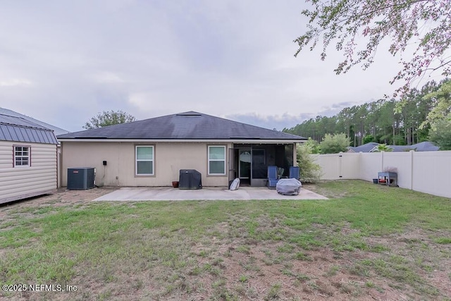 back of property featuring cooling unit and a patio