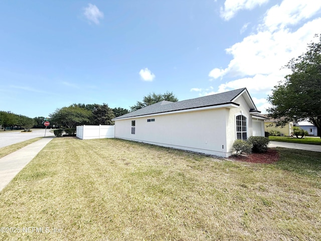 view of property exterior with stucco siding and a shingled roof