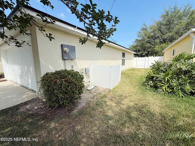 view of property exterior featuring stucco siding and a garage