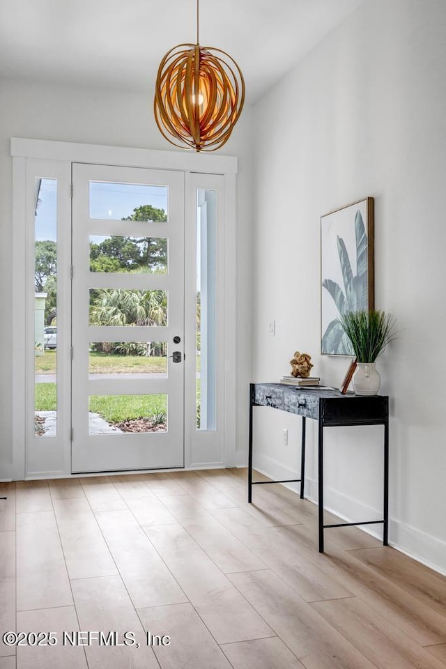 entryway featuring baseboards and light wood-style flooring