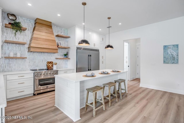 kitchen featuring open shelves, high end appliances, custom exhaust hood, decorative backsplash, and recessed lighting