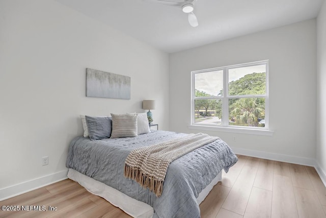bedroom with baseboards, light wood-style floors, and ceiling fan