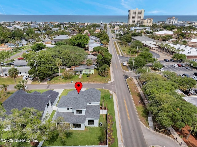 aerial view of property and surrounding area with a nearby body of water